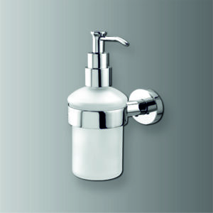 Modern wall-mounted soap dispenser with brushed metal finish dispensing soap into cupped hands in contemporary bathroom setting